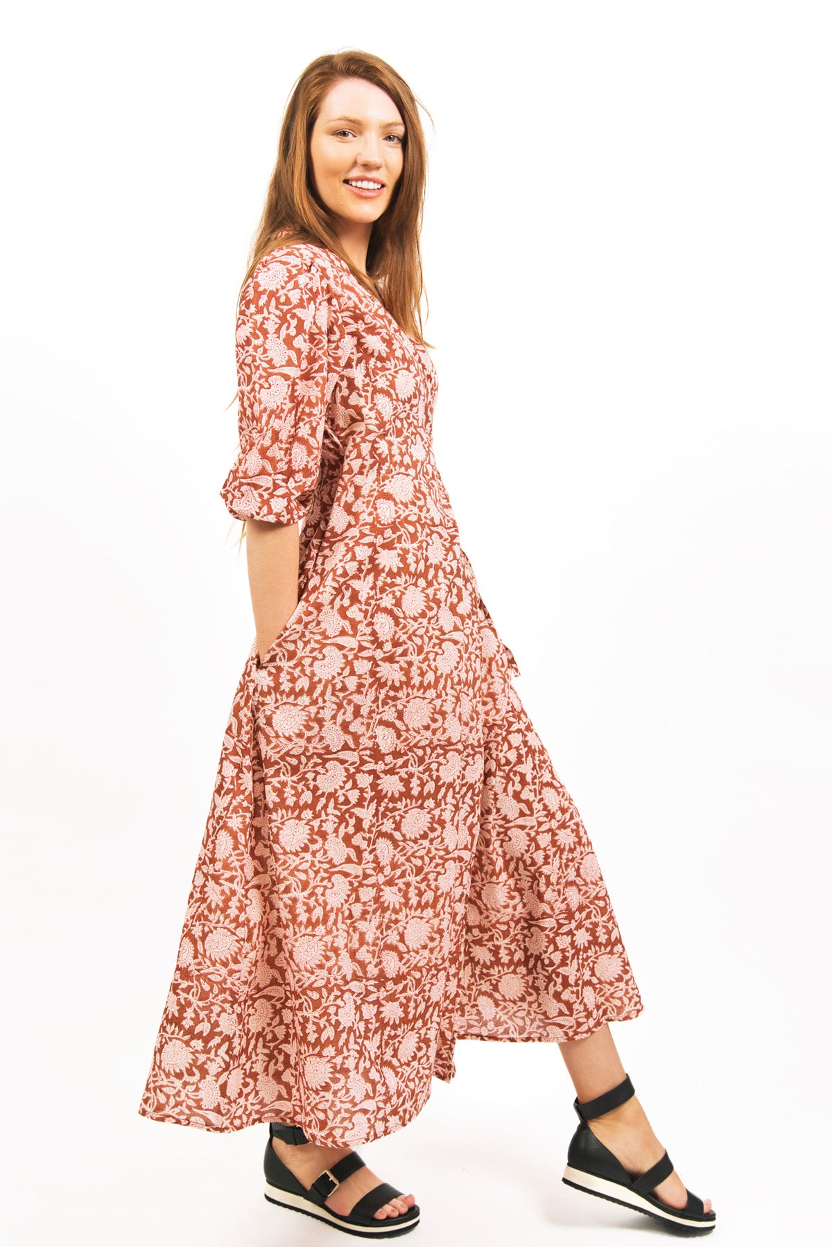 MODEL SHOT OF ZEPHYR PRINTED WRAP MAXI DRESS IN AMBER COLOR FLORAL BLOCK PRINT- zohaonline