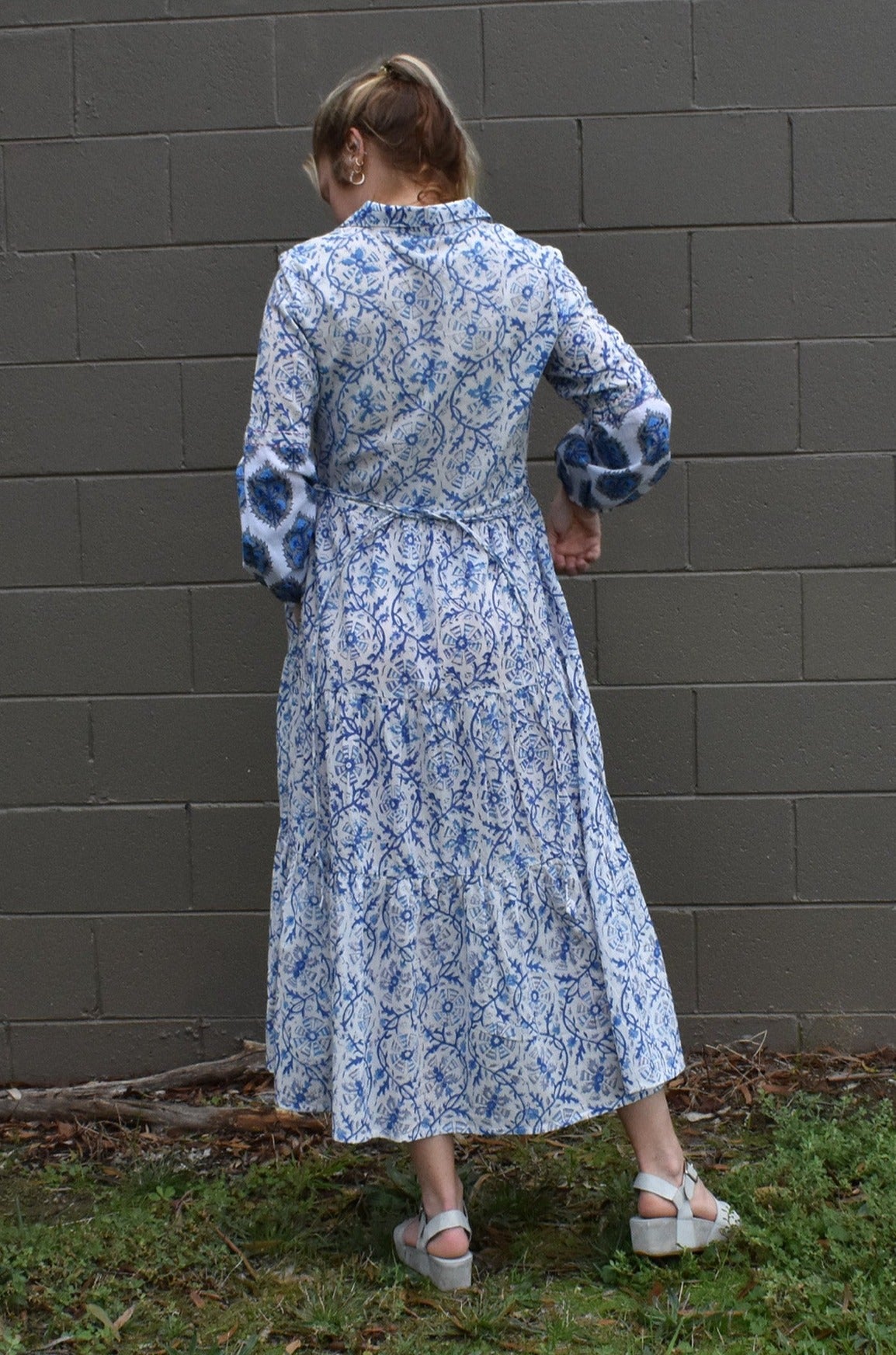 IRIS PRINTED TIERED MAXI DRESS- BACK VIEW ON A MODEL CASUALLY PAIRED WITH WEDGES - zohaonline