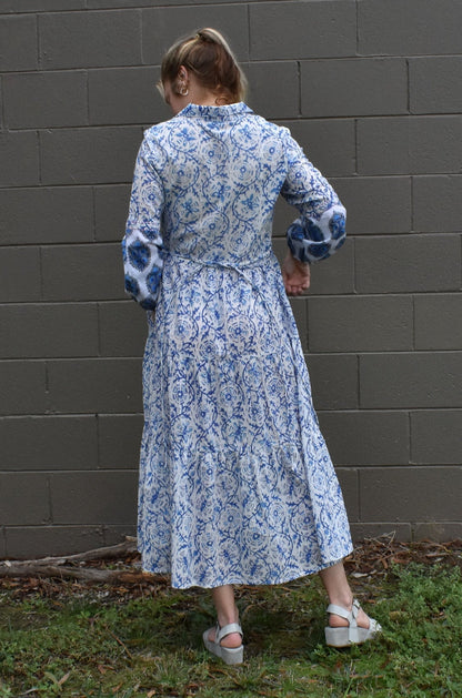 IRIS PRINTED TIERED MAXI DRESS- BACK VIEW ON A MODEL CASUALLY PAIRED WITH WEDGES - zohaonline