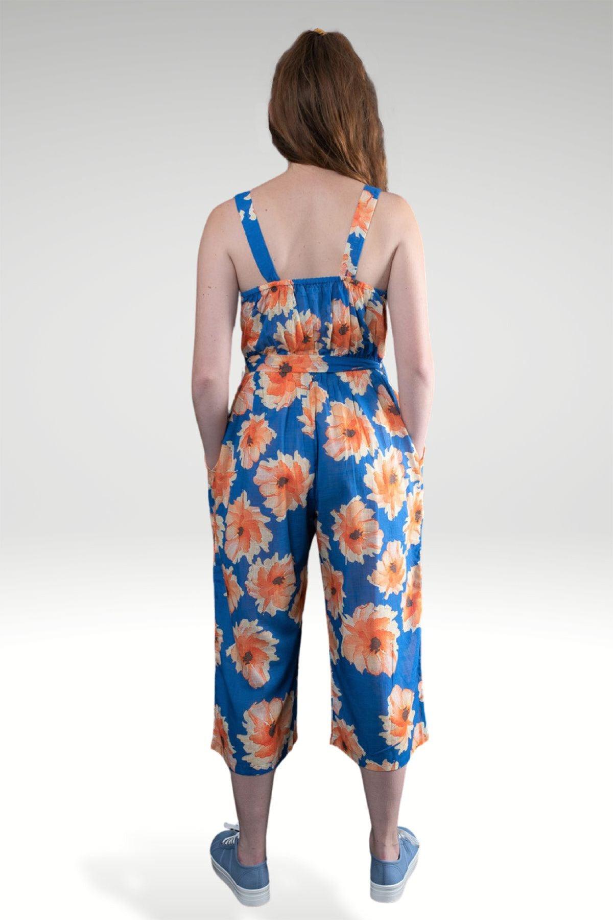 BACK VIEW OF THE MODEL WEARING BLUE JUMPSUIT- LARA FLORAL JUMSUIT- zohaonline