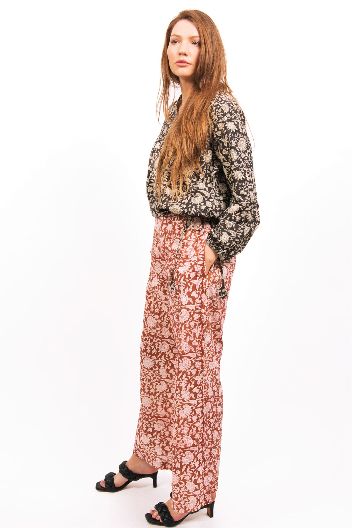 SIDE VIEW ON MODEL -AMBER FLARE PANTS -WORN WITH SABLE TOP AND BLACK SANDALS zohaonline